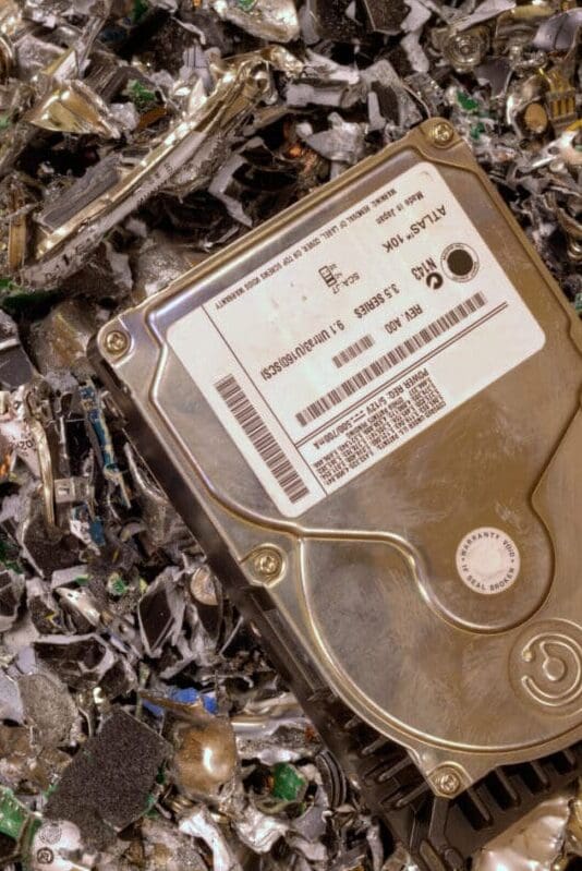 A computer hard drive is sitting on the ground.